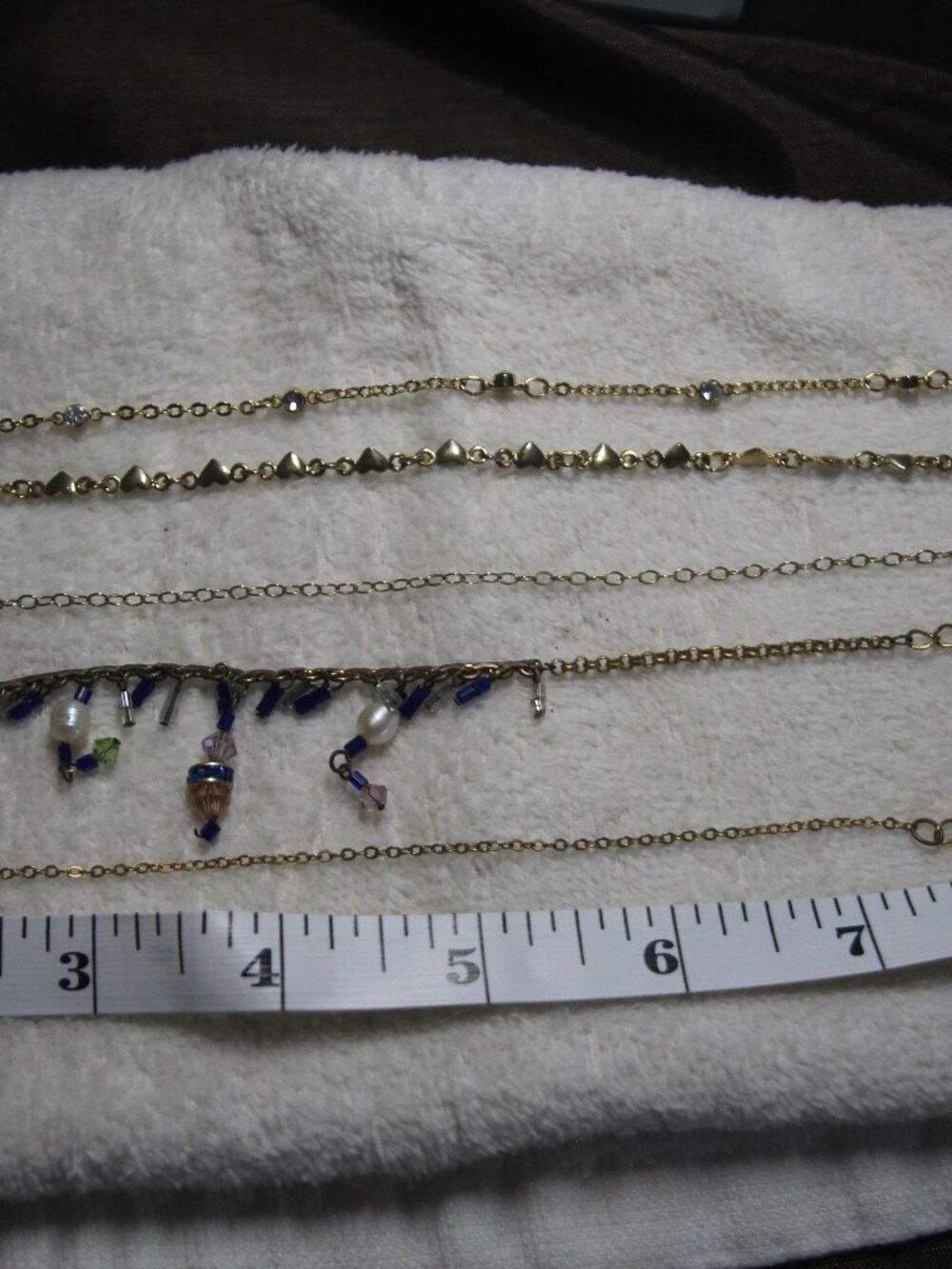 Anklets 5 for 1 price gold tone. Worn conidtion.